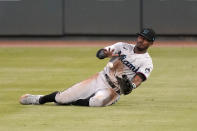 A ball hit for a single by Atlanta Braves' Ronald Acuna Jr., drops in front of Miami Marlins center fielder Lewis Brinson in the fourth inning of a baseball game Wednesday, Sept. 23, 2020, in Atlanta. (AP Photo/John Bazemore)