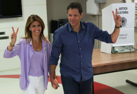 Fernando Haddad, presidential candidate of Brazil’s leftist Worker Party (PT), and his wife Ana Estela Haddad, gesture at the polling station in Sao Paulo, Brazil October 28, 2018. REUTERS/Paulo Whitaker