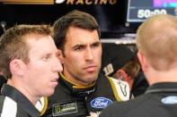 May 23, 2019; Concord, NC, USA; Monster Energy NASCAR Cup Series driver Aric Almirola (10) talks with crew members after his turn during practice for the Coca-cola 600 at Charlotte Motor Speedway. Mandatory Credit: Jim Dedmon-USA TODAY Sports