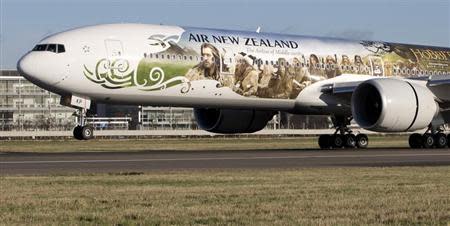 An Air New Zealand's Boeing 777-300ER featuring livery advertising the film The Hobbit: An Unexpected Journey lands at Heathrow Airport in London