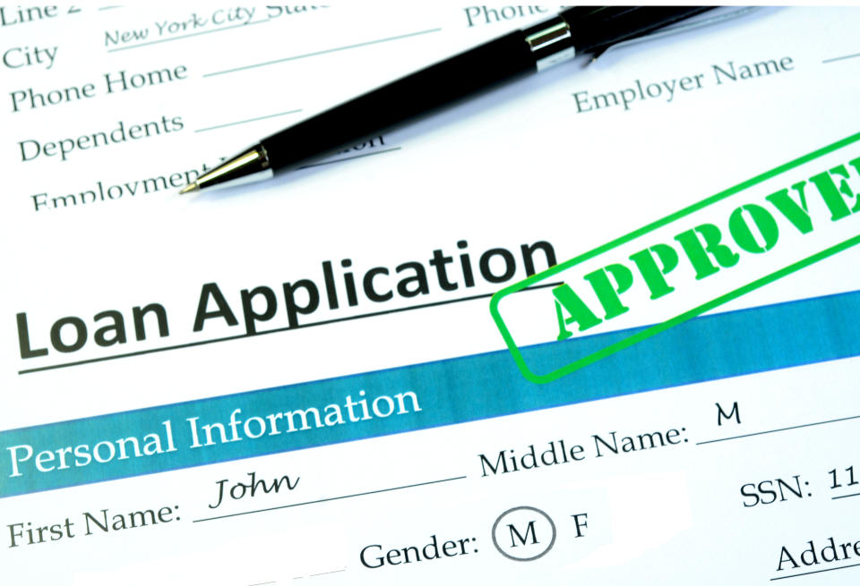 Loan application with approved stamp on it.