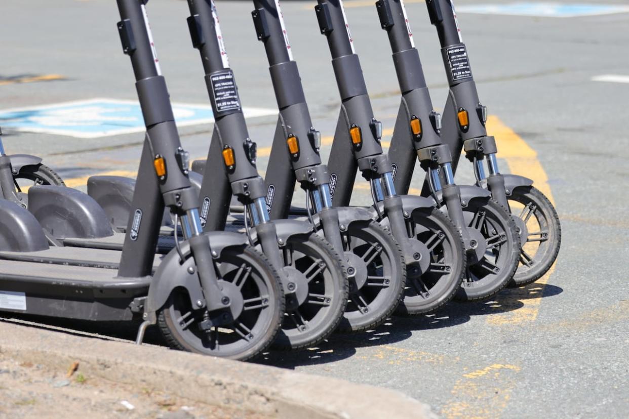 A row of HFX e-Scooters are parked on the Halifax waterfront (Rob Short/CBC - image credit)