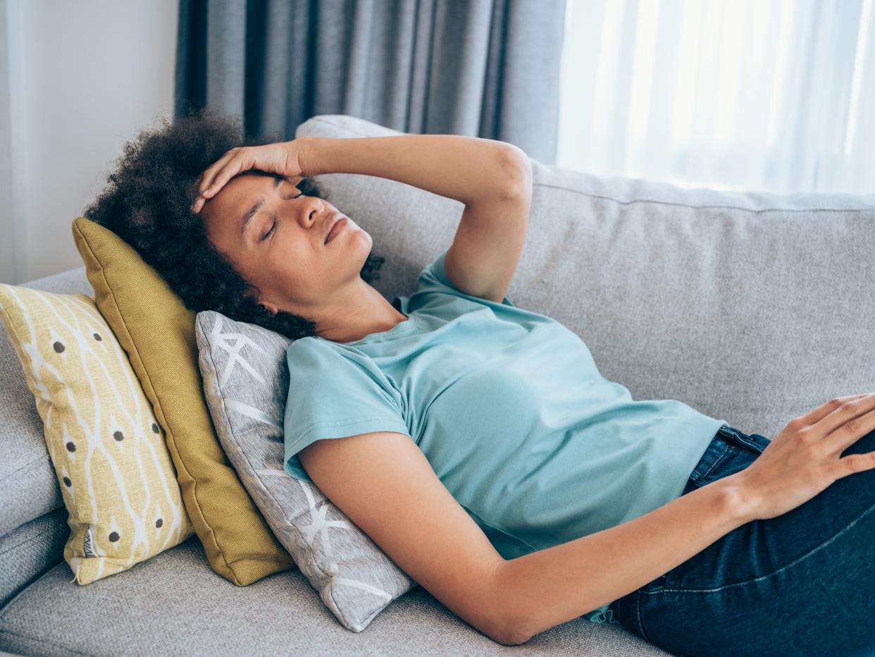 A woman lying on a sofa.