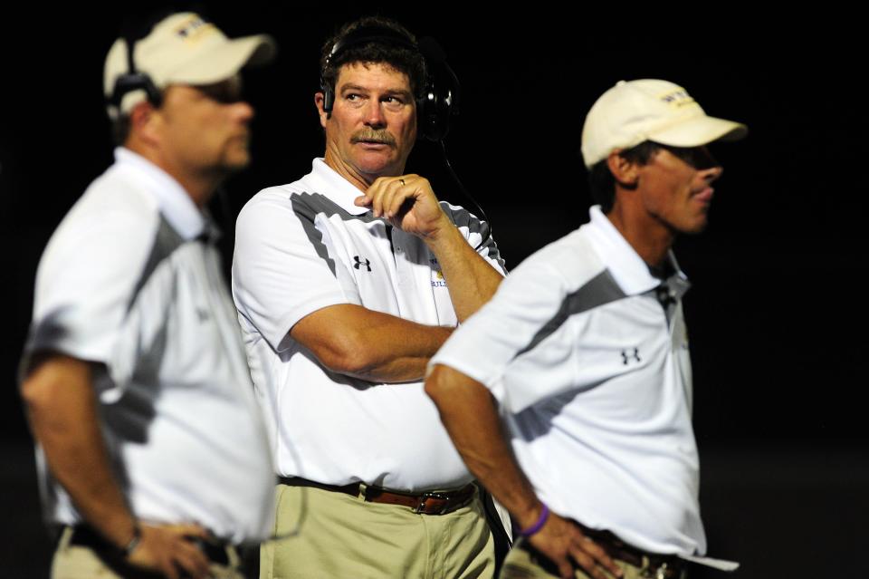 Wylie coach Hugh Sandifer stands between assistant coaches Chris Kincaid, left, and Clay Martin during a 2013 game. Martin joined Sandifer's staff in 1993 and followed Sandifer as head coach in 2020.