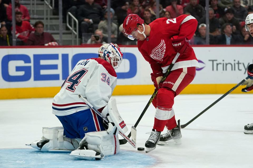 Montreal Canadiens goaltender Jake Allen (34) stops a Detroit Red Wings left wing Lucas Raymond (23) shot in the second period of an NHL hockey game Friday, Oct. 14, 2022, in Detroit. (AP Photo/Paul Sancya)