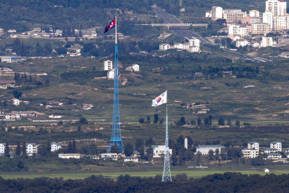 Flags of North Korea, rear, and South Korea, front, flutter in the wind as pictured from the border area between two Koreas in Paju, South Korea Monday, Aug. 9, 2021. The powerful sister of North Korean leader Kim Jong Un ripped South Korea for proceeding with military exercises with the United States she claimed are an invasion rehearsal and warned that the North will speed up its efforts to strengthen its pre-emptive strike capabilities. (Im Byung-shik/Yonhap via AP)