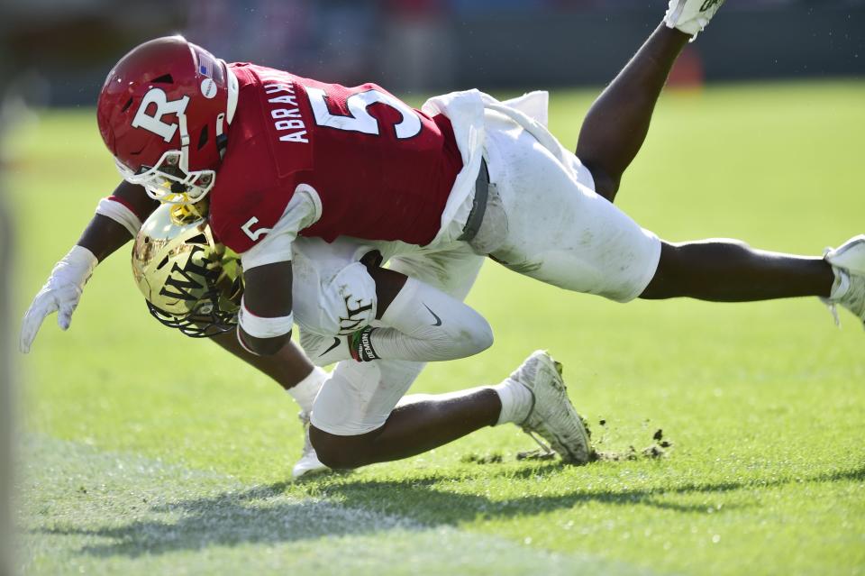 Wake Forest Demon Deacons wide receiver A.T. Perry (9) is tackled by Rutgers Scarlet Knights defensive back Kessawn Abraham (5) during the fourth quarter Friday, Dec. 31, 2021 at TIAA Bank Field in Jacksonville. The Wake Forest Demon Deacons and the Rutgers Scarlet Knights faced each other in the 2021 TaxSlayer Gator Bowl. Wake Forest defeated Rutgers 38-10. [Corey Perrine/Florida Times-Union]