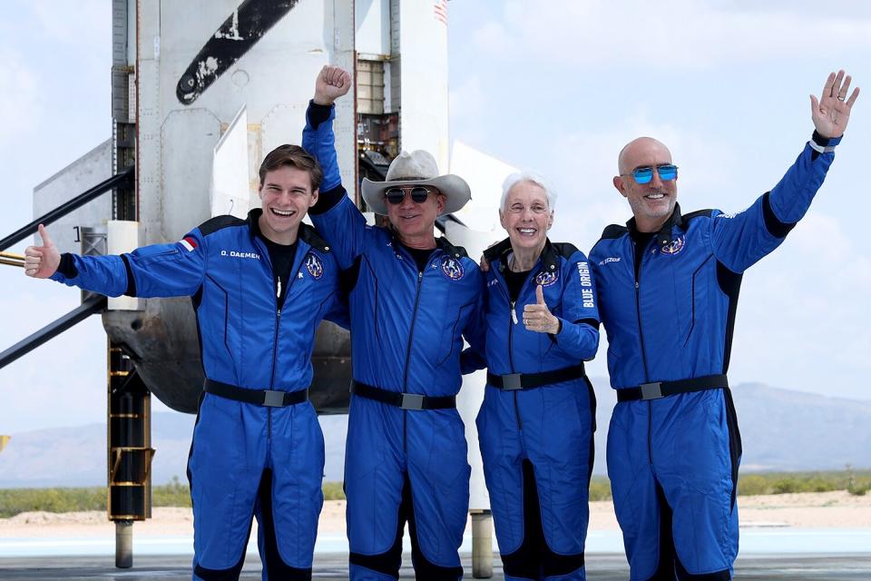 Blue Origin’s New Shepard crew (L-R) Oliver Daemen, Jeff Bezos, Wally Funk, and Mark Bezos pose for a picture near the booster after flying into space in the Blue Origin New Shepard rocket on July 20, 2021 in Van Horn, Texas. Mr. Bezos and the crew were the first human spaceflight for the company.