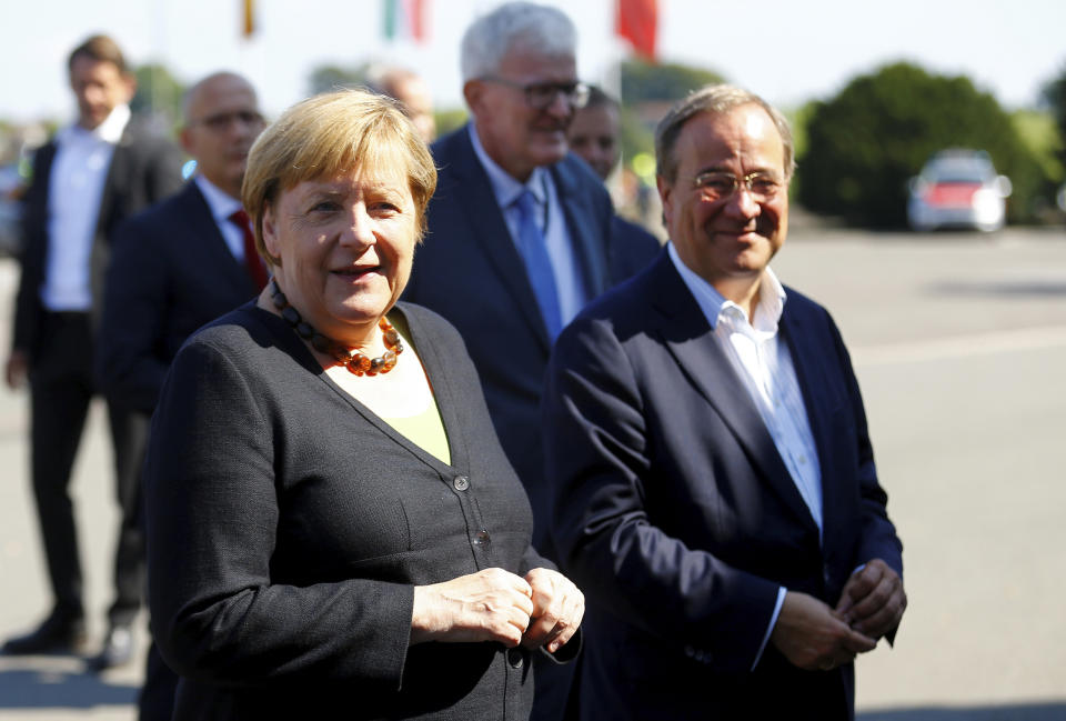 German Chancellor Angela Merkel and North Rhine-Westphalia's State Premier, chairman of the Christian Democratic Union party and candidate for Chancellery Armin Laschet, right, visit the fire station in Schalksmuehle, Germany, Sunday Sept. 5, 2021. (Thilo Schmuelgen/Pool via AP)