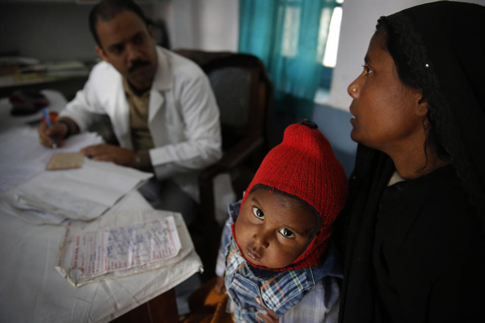 In this Saturday, Feb. 1, 2014 photo, a doctor attends to Anwar, 4, infected with tuberculosis at the Kashi Vidyapith block hospital in Kotawa near Varanasi, India. India has the highest incidence of TB in the world, according to the World Health Organization's Global Tuberculosis Report 2013, with as many as 2.4 million cases. India saw the greatest increase in multidrug-resistant TB between 2011 and 2012. The disease kills about 300,000 people every year in the country. (AP Photo/Rajesh Kumar Singh)