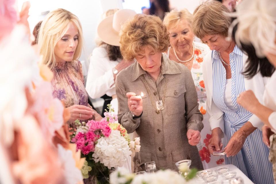 Dinie Scheiner (left) of Palm Beach Synagogue leads a prayer during a bat mitzvah celebration for 18 women on April 12.