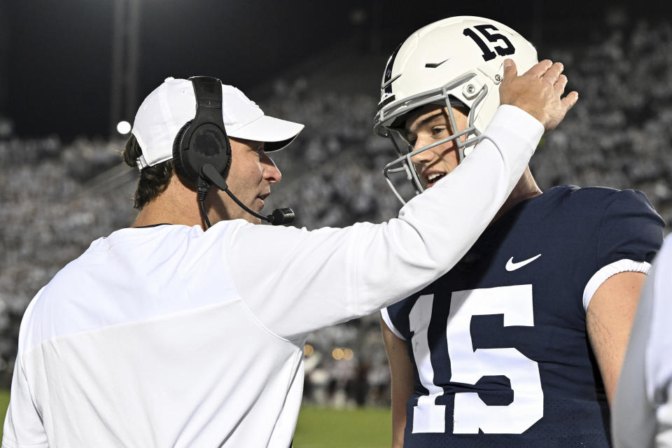 FILE - Penn State offensive coordinator Mike Yurcich talks with quarterback Drew Allar (15) in the second half of an NCAA college football game against Minnesota, Saturday, Oct. 22, 2022, in State College, Pa. The former five-star quarterback recruit has the potential to be the type of leader the Nittany Lions need to bust up the recent Michigan/Ohio State monopoly in the Big Ten.(AP Photo/Barry Reeger, File)