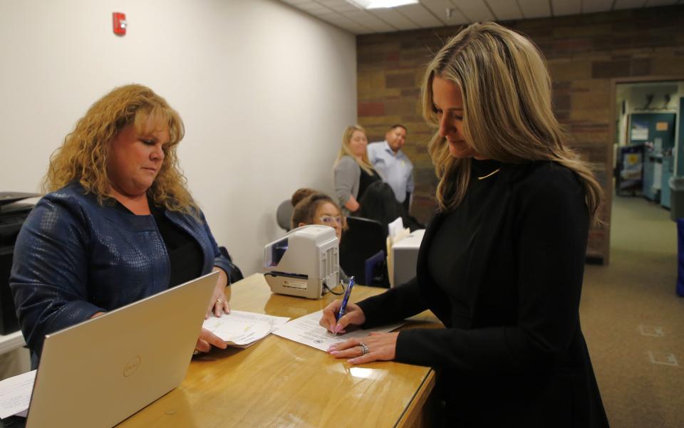 San Juan County Clerk Tanya Shelby, left, watches Alyssa Kuhn fill out her paperwork as a Republican candidate for county clerk during filing day on Tuesday, March 12 in the San Juan County Administration Building in Aztec.
