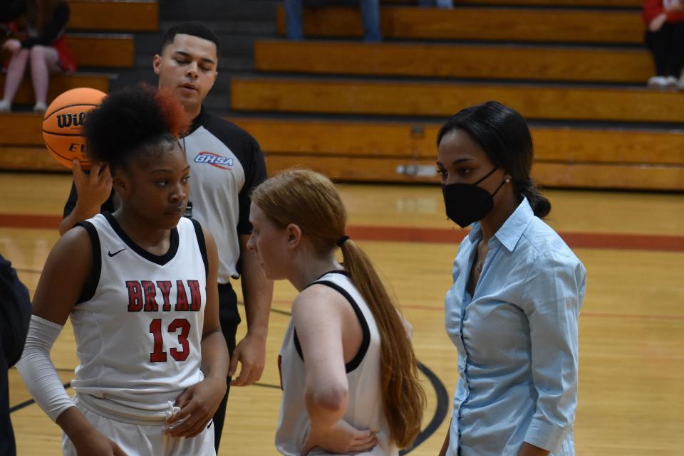 Bryan County assistant girls basketball coach Yasmine Crawford, right, gives instructions to Ashanti Brown (13) and Emery Adams.