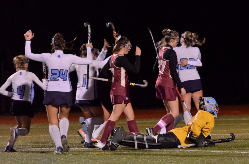 CANTON -- 11/16/22 -- Sandwich players celebrate Quinn Jordan's goal as Newburyport goalie Jane Mettling picks herself up off the ground after trying to block the ball. 
Sandwich High School played Newburyport High School in Division 3 state semifinal field hockey action Wednesday at Canton High School. Sandwich won 1-0.