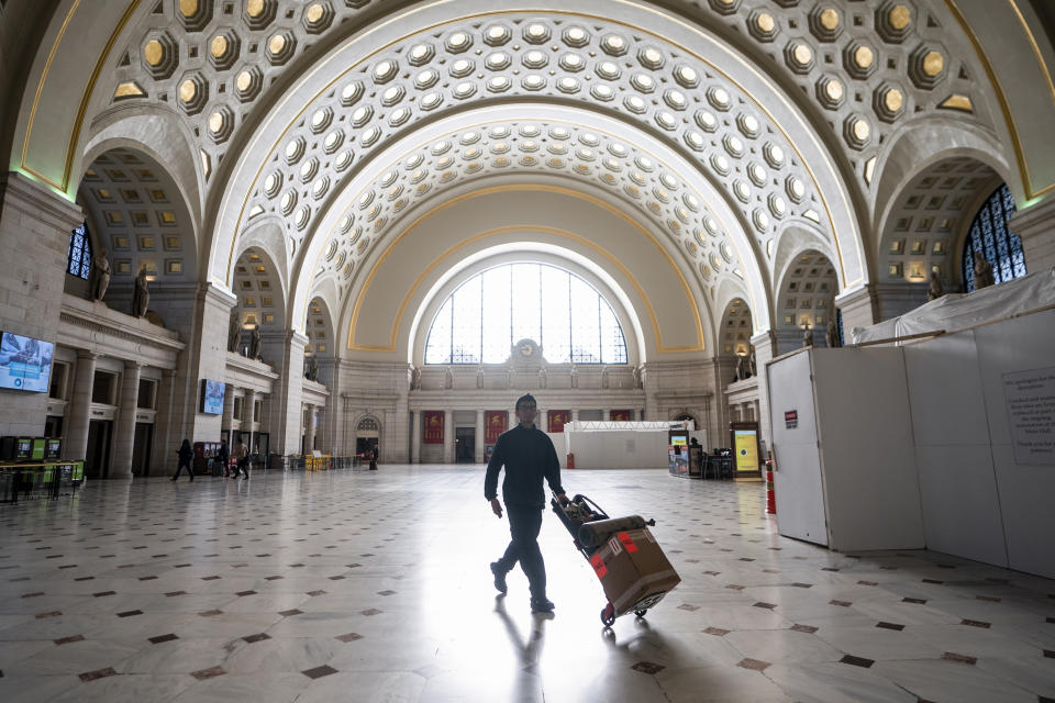 Washington Union Station, a major transportation hub in the nation's capital, is nearly empty during morning rush hour as many government and private sector workers stay home during the coronavirus outbreak, in Washington, Monday, March 16, 2020. (AP Photo/J. Scott Applewhite)