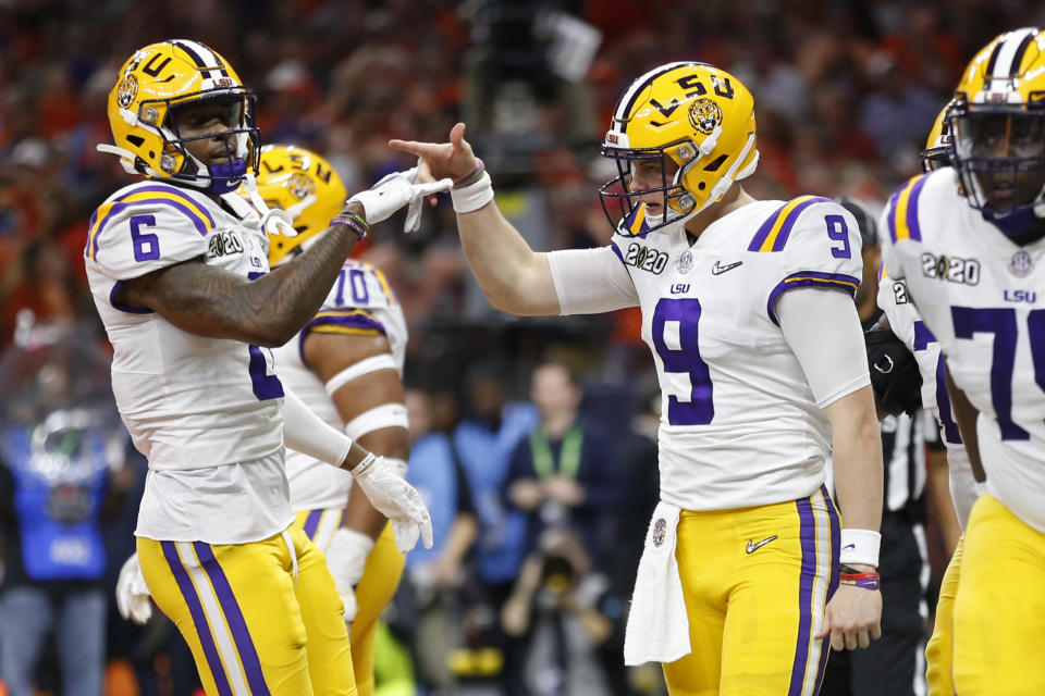 LSU quarterback Joe Burrow, right, celebrates with wide receiver Terrace Marshall Jr. after scoring against Clemson during the first half of a NCAA College Football Playoff national championship game Monday, Jan. 13, 2020, in New Orleans. (AP Photo/Gerald Herbert)