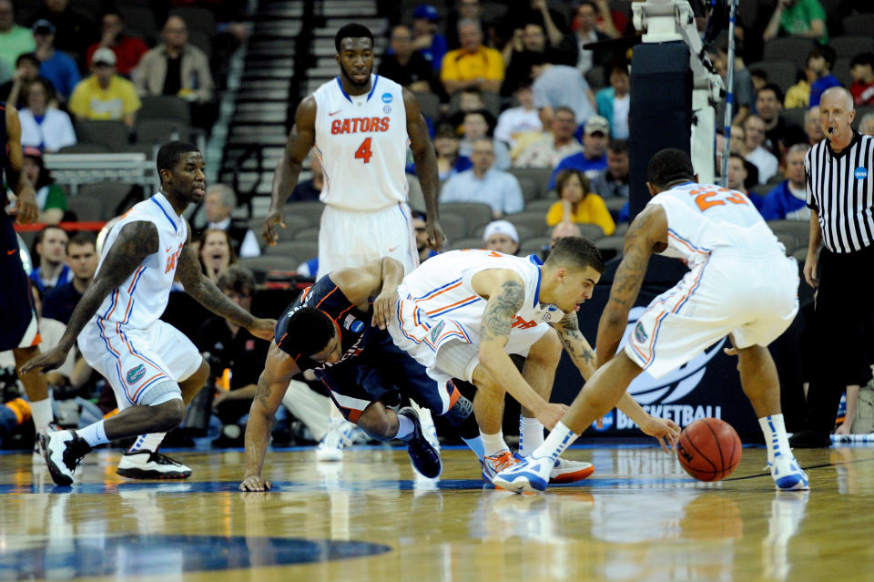 OMAHA, NE - MARCH 16: Scottie Wilbekin #5 (C) and Bradley Beal #23 of the Florida Gators fight for a loose ball against Jontel Evans #1 of the Virginia Cavaliers during the second round of the 2012 NCAA Men's Basketball Tournament at CenturyLink Center on March 16, 2012 in Omaha, Nebraska. (Photo by Eric Francis/Getty Images)