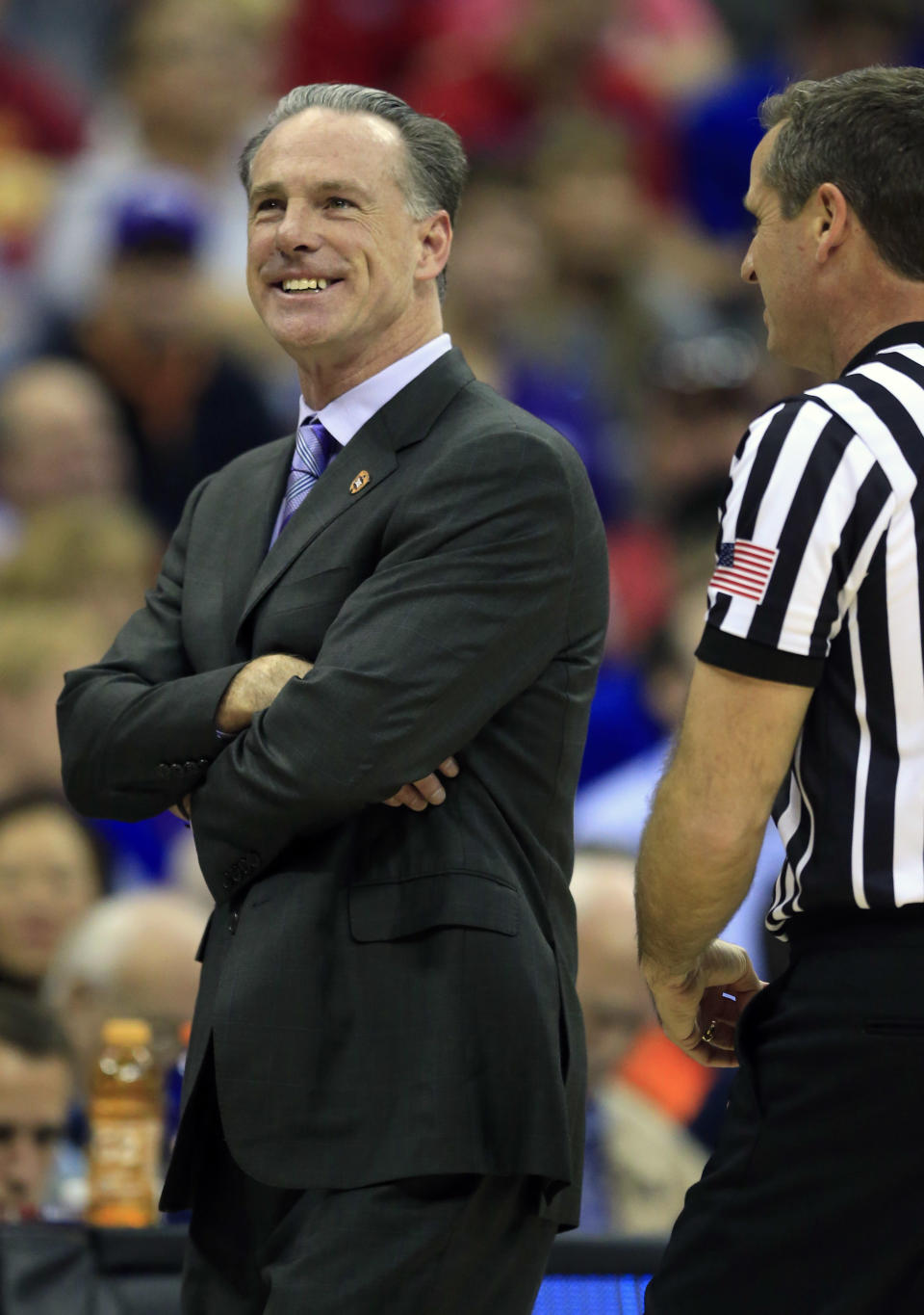 TCU head coach Jamie Dixon smiles after a call during first half of an NCAA college basketball game against Kansas in the quarterfinal round of the Big 12 tournament in Kansas City, Mo., Thursday, March 9, 2017. (AP Photo/Orlin Wagner)