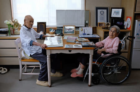 World's oldest living married couple Masao Matsumoto (L) and Miyako Matsumoto look at albums in their room at a nursing house in Takamatsu, Kagawa prefecture, Japan September 4, 2018. REUTERS/Kwiyeon Ha