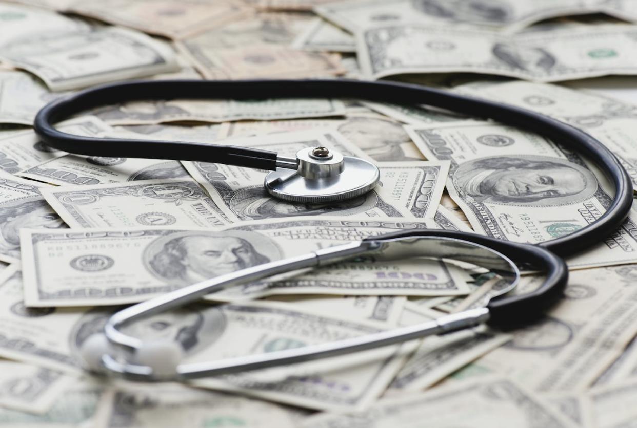 Medical debt can have devastating consequences. <a href="https://www.gettyimages.com/detail/photo/stethscope-on-pile-of-us-banknotes-royalty-free-image/153349316" rel="nofollow noopener" target="_blank" data-ylk="slk:PhotoAlto/Odilon Dimier via Getty Images;elm:context_link;itc:0;sec:content-canvas" class="link ">PhotoAlto/Odilon Dimier via Getty Images</a>