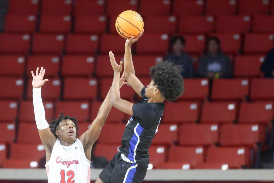 Southeast's Ladainian Fields shoots over Memorial's Montae Collins during a 5A semifinal game between Memorial and Southeast at Lloyd Noble Center in Norman, Okla. on Friday, March 11, 2022. 