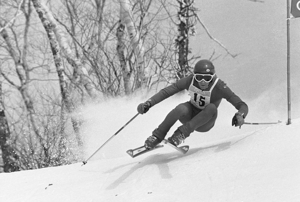 FILE - Mike Lafferty, Eugene, Ore. in Sapporo non-stop training run of Olympic men?s downhill on Mt. Eniwa track in which he finished fifth, Feb. 6, 1972. The northern Japanese city of Sapporo is set to announce on Monday, Nov. 29, 2021, what it says will be a reduction in costs that will make it an attractive venue for the 2030 Winter Olympics. (AP Photo/Michel Lipchitz, File)