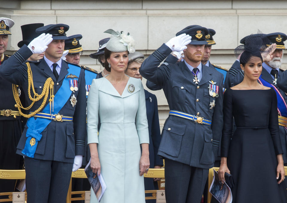 FILE - Attending a ceremonial event, from front left, Prince William, Kate the Duchess of Cambridge, Prince Harry and Meghan the Duchess of Sussex, with various other dignitaries and guests, before watching a flypast of Royal Air Force aircraft pass over Buckingham Palace in London, Tuesday, July 10, 2018. Prince Harry has said he wants to have his father and brother back and that he wants “a family, not an institution,” during a TV interview ahead of the publication of his memoir. The interview with Britain’s ITV channel is due to be released this Sunday. (Paul Grover/Pool via AP)