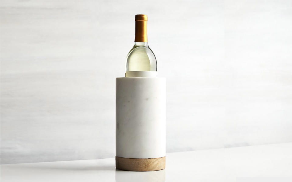 <p>This mango wood and white marble wine cooler keeps a bottle cool for hours—and will look right at home on anyone’s kitchen table or counter.</p> <p>To buy: <a rel="nofollow noopener" href="http://www.anrdoezrs.net/links/7876402/type/dlg/sid/TLTRVggG250Under%2450EO1Sep/http://www.crateandbarrel.com/wood-and-marble-wine-cooler/s677465" target="_blank" data-ylk="slk:Crate & Barrel;elm:context_link;itc:0;sec:content-canvas" class="link ">Crate & Barrel</a>, $39.95</p>