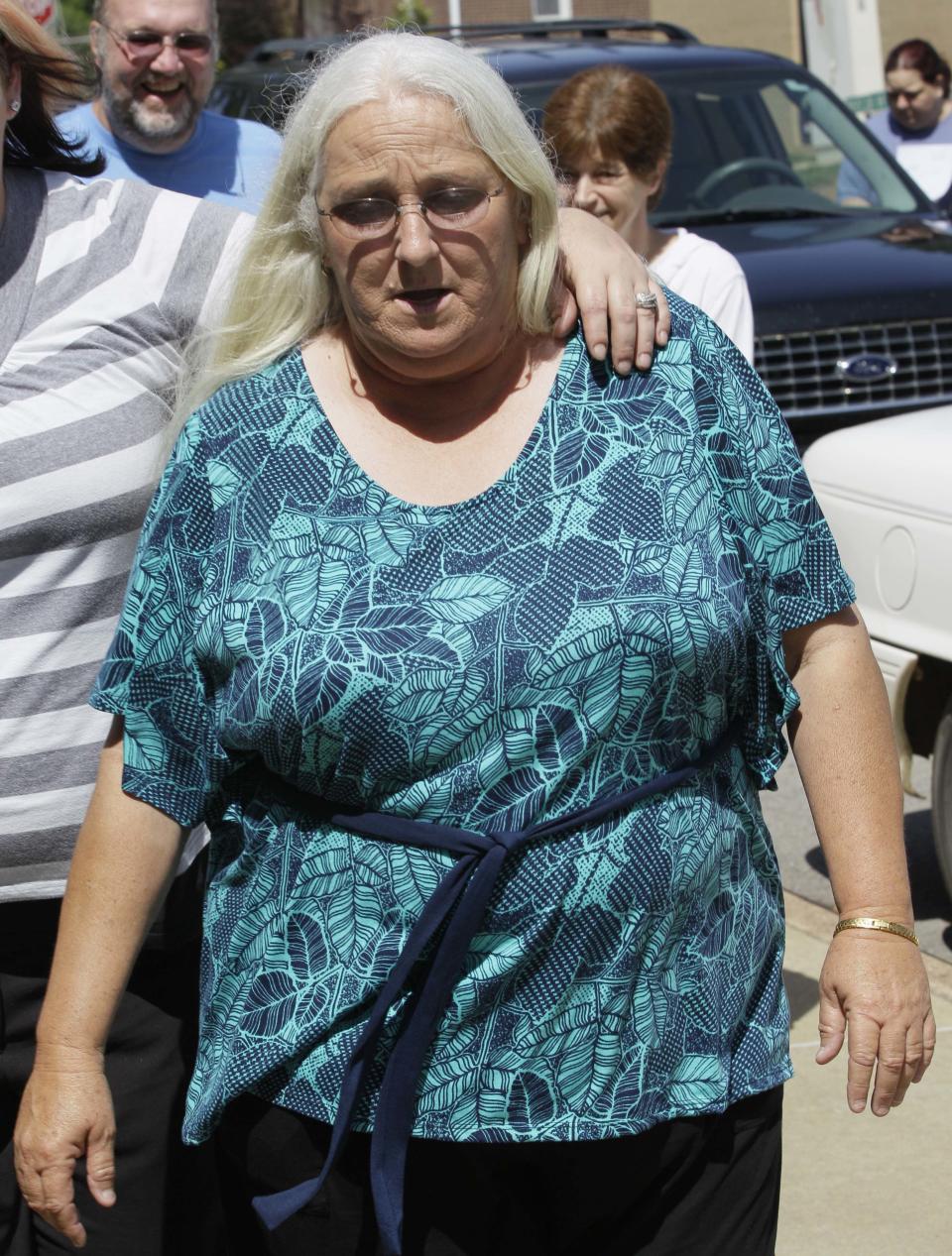 Sharon Jones, center, who cashed a winning lottery ticket after taking it from a bin of discarded tickets July 15, 2011, at a Beebe, Ark., convenience store, walks to a court house during a break in a trial in Searcy, Ark., Tuesday, May 1, 2012. (AP Photo/Danny Johnston)