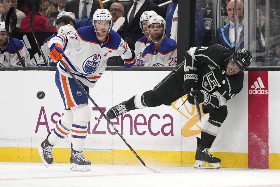 Los Angeles Kings center Anze Kopitar, right, passes the puck while under pressure from Edmonton Oilers center Connor McDavid during the second period in Game 4 of an NHL hockey Stanley Cup first-round playoff series Sunday, April 28, 2024, in Los Angeles. (AP Photo/Mark J. Terrill)