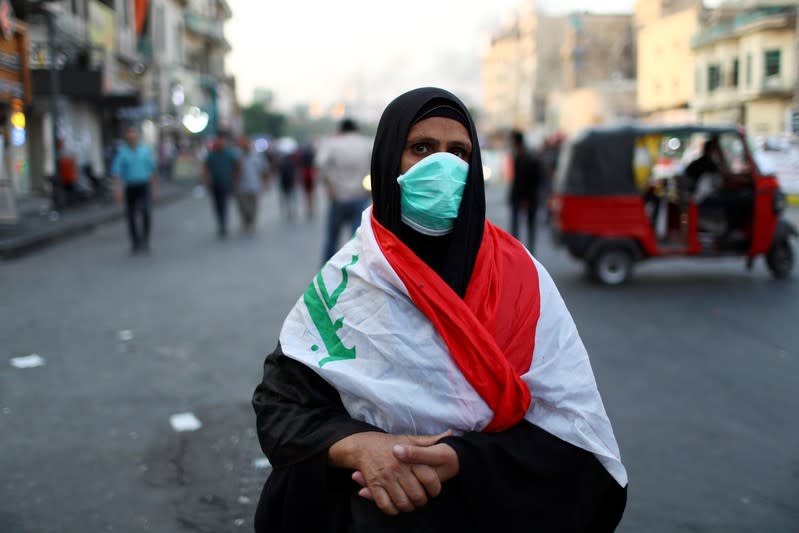 Salwa Hussein, an Iraqi woman demonstrator, poses for a photograph during the ongoing anti-government protests in Baghdad