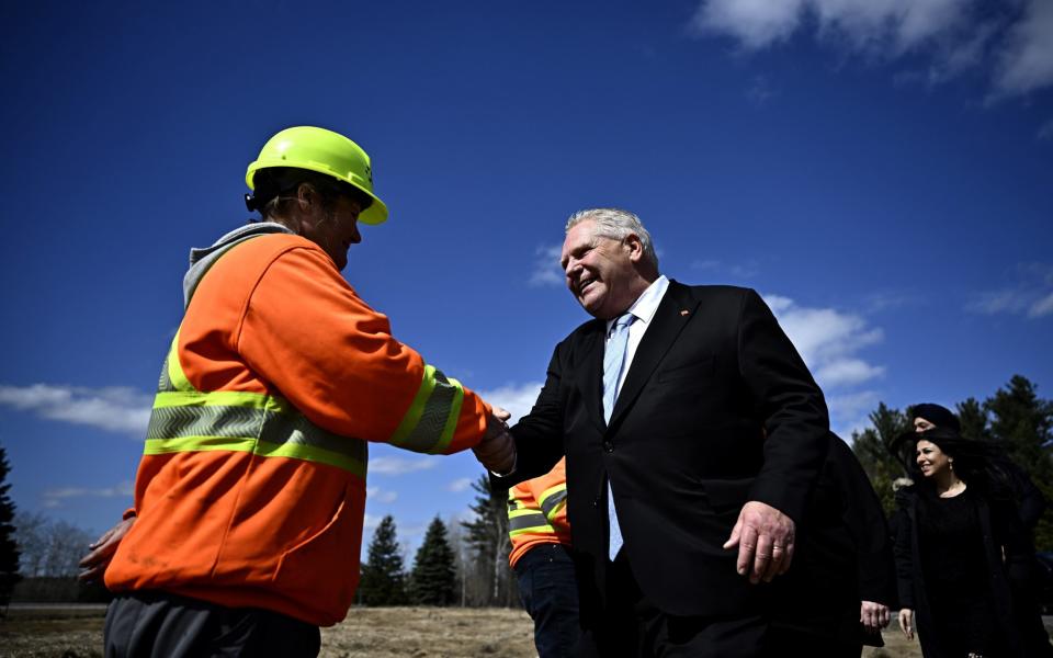 Doug Ford shakes hands with a construction worker