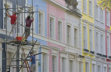 Scaffolders work on a residential street in Notting Hill in central London October 8, 2013. REUTERS/Toby Melville