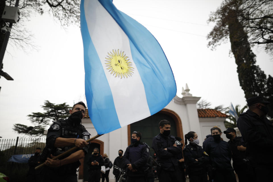 Buenos Aires provincial police protest outside the residence of the nation's president, to protest for better wages and working conditions amid the new coronavirus pandemic in Olivos, on the outskirts of Buenos Aires, Argentina, Wednesday, Sept. 9, 2020. (AP Photo/Natacha Pisarenko)