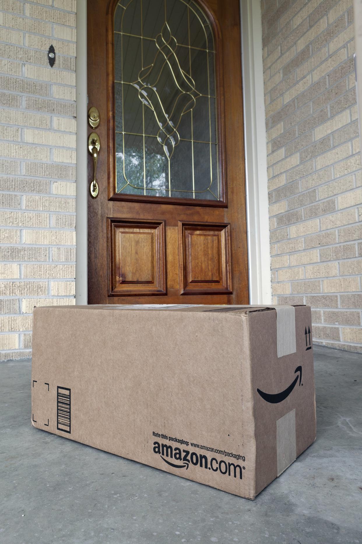 Amazon.com package at front door of house