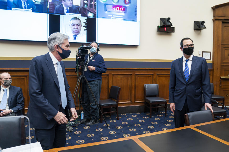 Federal Reserve Chair Jerome Powell, left, and Treasury Secretary Steven Mnuchin arrive for a House Financial Services Committee hearing on Capitol Hill in Washington, Wednesday, Dec. 2, 2020. (Jim Lo Scalzo/Pool via AP)