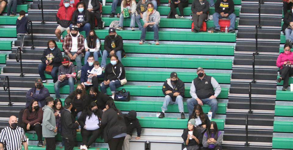 Fans, a vast majority of them wearing masks, attending a game at the Marv Sanders Invitational in the Scorpion Arena at Farmington High School on Saturday, Dec. 18, 2021.