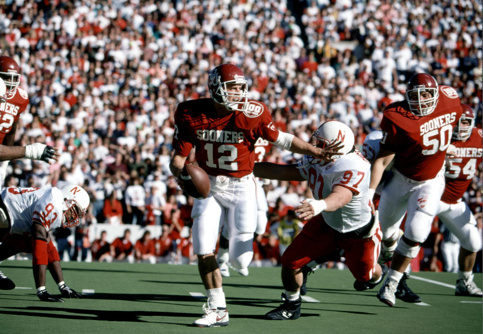 Nov. 23, 1990; Norman; Oklahoma Sooners quarterback Cale Gundy (12) is chased by Nebraska Cornhuskers defensive lineman Pat Englebert (97) at Memorial Stadium during the 1990 season. RVR Photos-USA TODAY Sports