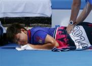 Luksika Kumkhum of Thailand receives treatment during a medical timeout in her women's singles match against Mona Barthel of Germany at the Australian Open 2014 tennis tournament in Melbourne January 15, 2014. REUTERS/David Gray