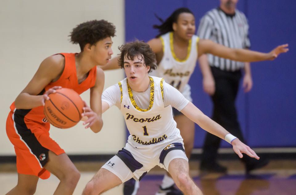 Peoria Christian's Malachi Persinger (1) defends against Illini Bluffs' Devon White in the second half Friday, Jan. 20, 2023 at Peoria Christian High School. The Tigers defeated the Crusaders 45-35.