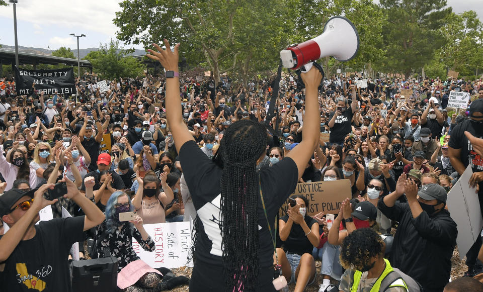 A demonstrator speaks during a protest, Saturday, June 6, 2020, in Simi Valley, Calif. over the death of George Floyd. Protests continue throughout the country over the death of Floyd, a black man who died after being restrained by Minneapolis police officers on May 25. (AP Photo/Mark J. Terrill)