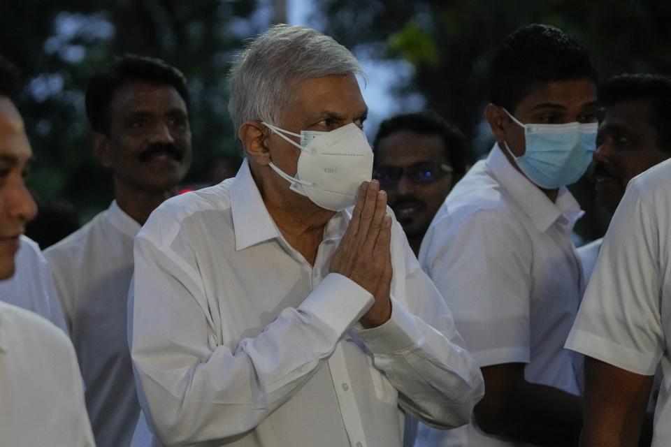 President elect Ranil Wickremesinghe greats supporters upon his arrival at a buddhist temple in Colombo, Sri Lanka, Wednesday, July 20, 2022. Wickremesinghe was elected president Wednesday by lawmakers who opted for a seasoned, veteran leader to lead the country out of economic collapse, despite widespread public opposition. (AP Photo/Eranga Jayawardena)