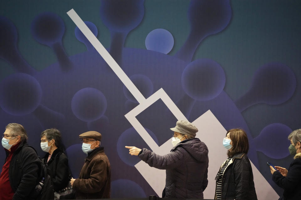 People queue to get vaccinated against COVID-19 on the first day of a new vaccination center in Lisbon, Wednesday, Dec. 1, 2021. Long lines formed at the Portuguese capital's largest vaccination center to date as authorities there tried to encourage the 2% of the population who are not vaccinated yet, Europe's lowest rate, and to speed up the administration of booster shots. Despite its excellent vaccination record, cases have been rising non-stop over the past two months, although hospitalizations are far away from levels seen in previous surges. (AP Photo/Armando Franca)