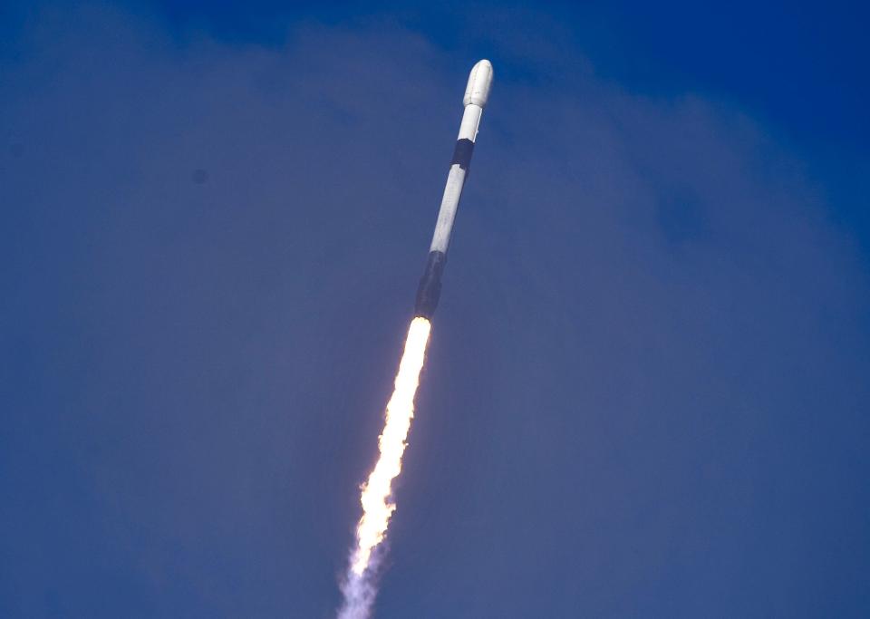 A SpaceX Falcon 9 rocket streaks through the clouds Sunday after liftoff from Cape Canaveral Space Force Station.