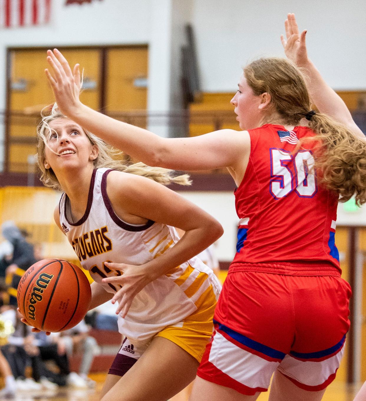 North's Kenli Sullivan (13) shoots around Owen Valley's Reagan Martin (50) during the Bloomington North versus Owen Valley girls basketball game at Bloomington North High School on Tuesday, Dec. 6, 2022.