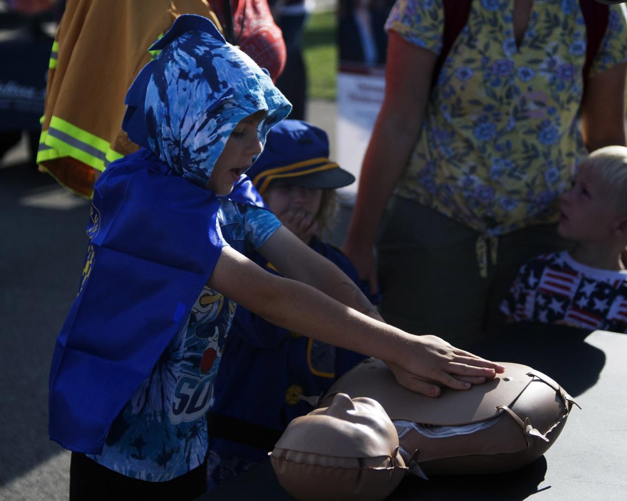 Delaware resident Eli Marshall works on a CPR dummy at the Touch-A-Truck event Aug. 13, 2022 at Olentangy Berlin High School. Following the success of their first Touch-a-Truck event in June 2022, the Delaware County Emergency Medical Services Department partnered with the Berlin Township Fire Department to host a second event.