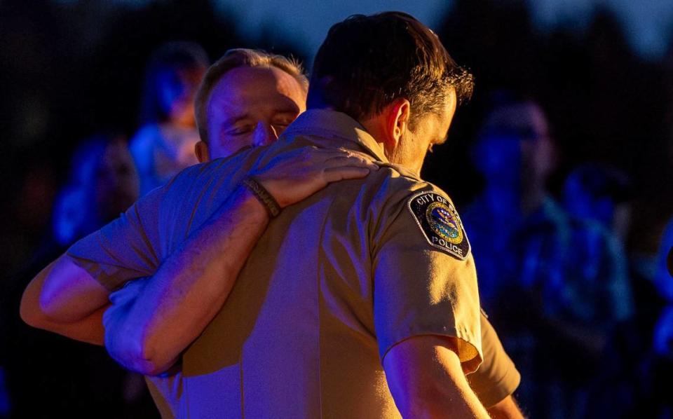 Ada County Sheriff Matt Clifford hugs Star Police Chief and Ada County Sheriff’s Sergeant Zach Hessing as the two share comments with hundreds of people who gathered to honor Deputy Tobin Bolter at a vigil ceremony in Star, Tuesday, April 23, 2024. Bolter was killed in the line of duty this past weekend. Members of the law enforcement community, friends, and supporters met at Hunter’s Creek Sports Park for the vigil.