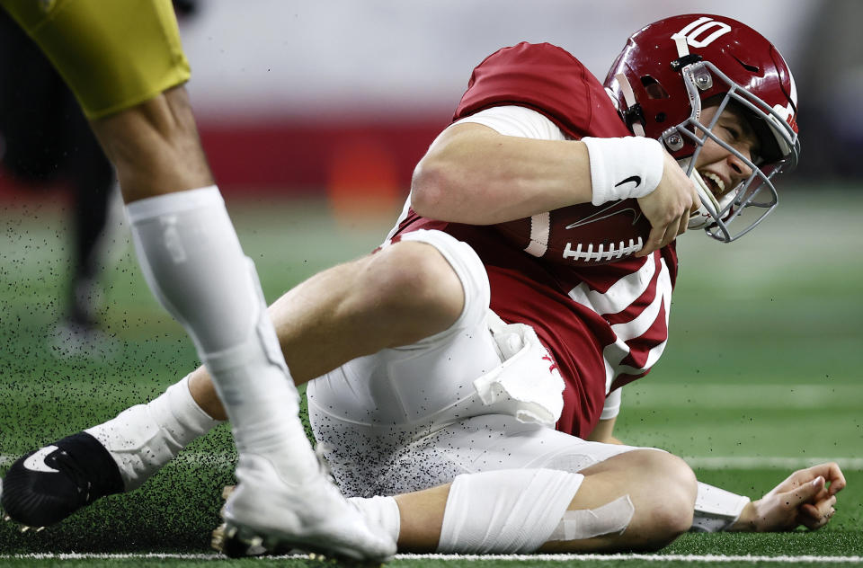ARLINGTON, TEXAS - JANUARY 01: Quarterback Mac Jones #10 of the Alabama Crimson Tide slides after a run against the Notre Dame Fighting Irish during the third quarter of  the 2021 College Football Playoff Semifinal Game at the Rose Bowl Game presented by Capital One at AT&T Stadium on January 01, 2021 in Arlington, Texas. (Photo by Tom Pennington/Getty Images)