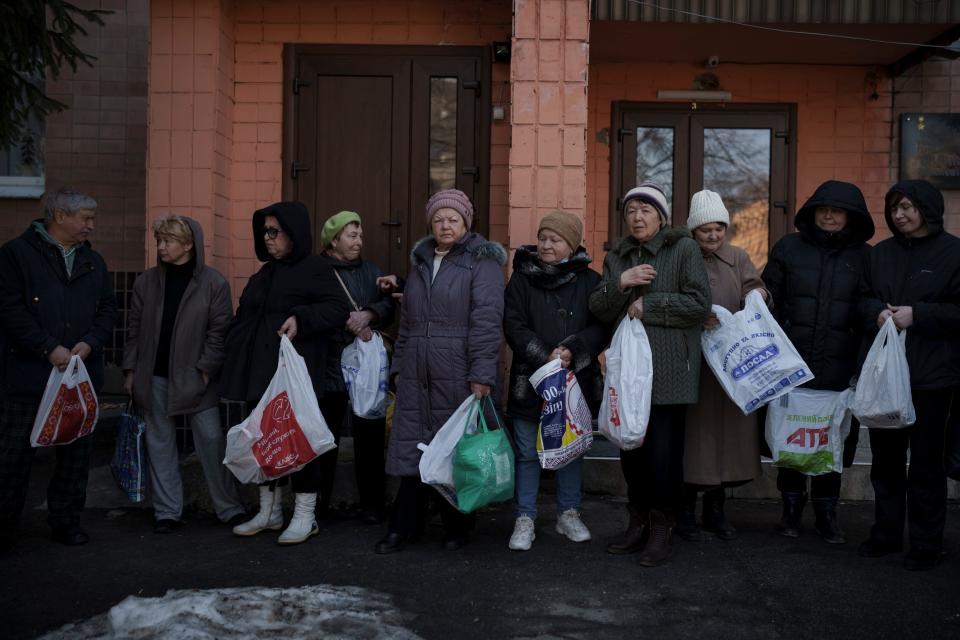 Residents wait in line to receive aid from the Ukrainian Red Cross in Kharkiv, Ukraine, on March 24,2022.